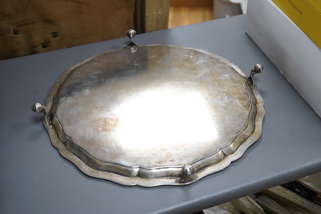A George VI silver salver, of shaped circular form, on four claw and ball feet, with presentation inscription, Reid & Sons, London, 1936, 35.7cm, 40.5oz.